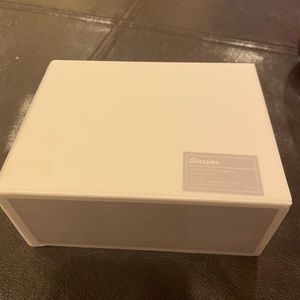 Glossier cranberry lip trio; Ultralip, gloss, generation g in neutral toned red.